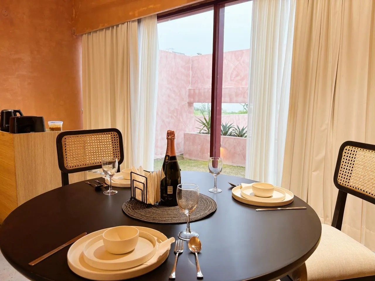 Dining table set for two by the garden window