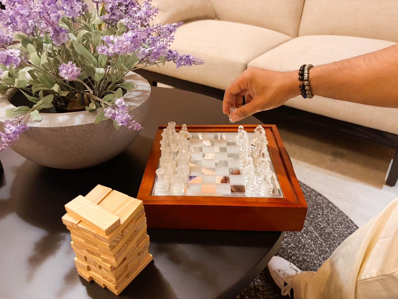 A glass chess set and stacking blocks on the coffee table