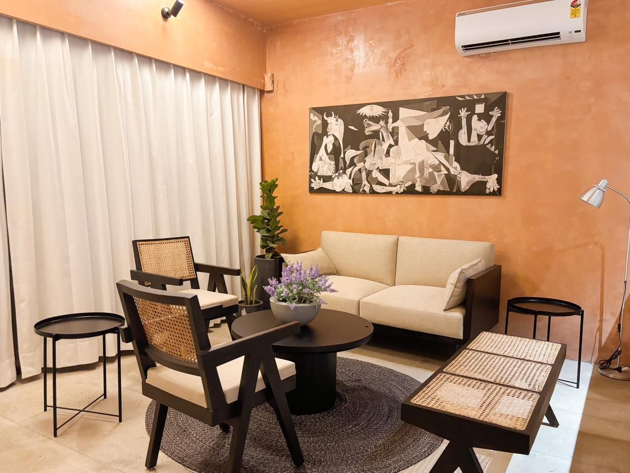 Apricot Garden Courtyard living room with cane chairs and a cream sofa